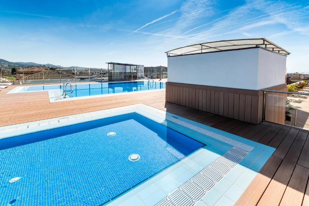 a swimming pool on the roof of a building at Apartaments Condado by Marsol in Lloret de Mar