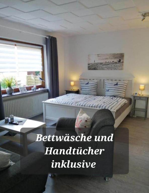 a bedroom with a bed and a living room at Steinmarner Bude 2 in Cuxhaven