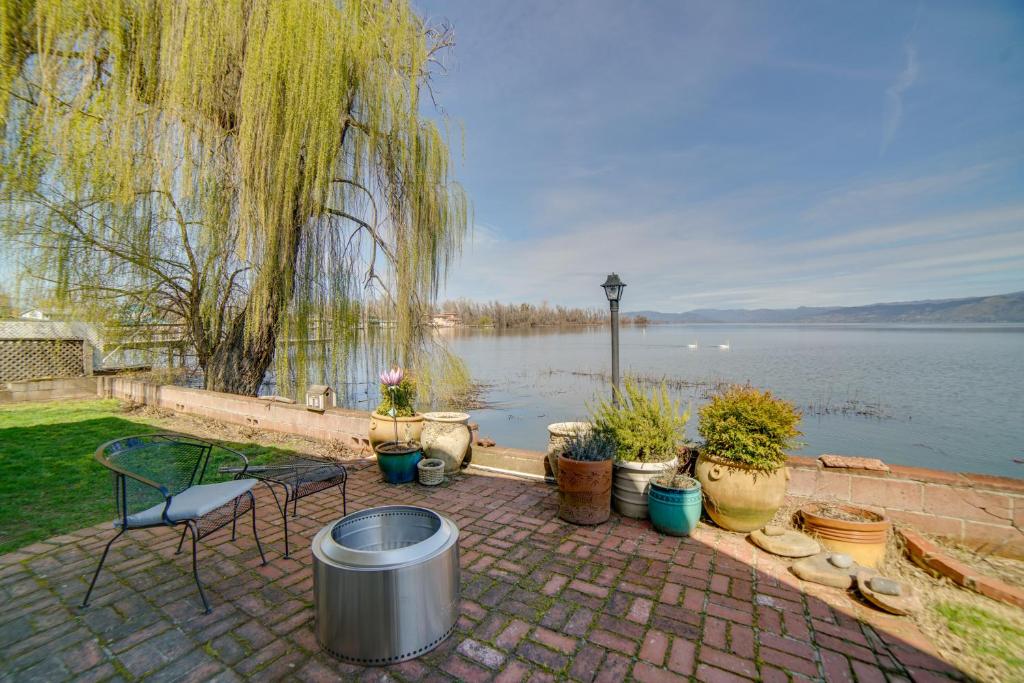 a patio with a table and chairs and plants at Waterfront Lakeport Rental Home with Private Dock! in Lakeport