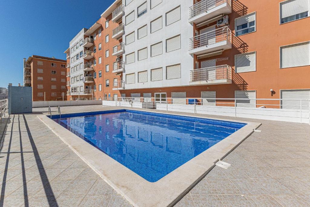 a swimming pool in front of a building at Shinning View Apartment in Armação de Pêra