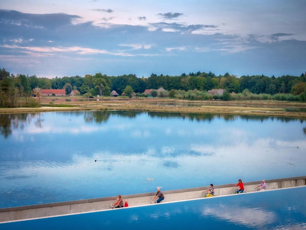 a group of people walking around a large lake at Cosy appartement Kur 62 Hasselt in Hasselt