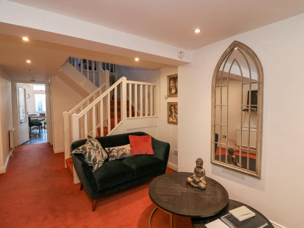 a living room with a green couch and a table at 83 Upper John Street in Wexford
