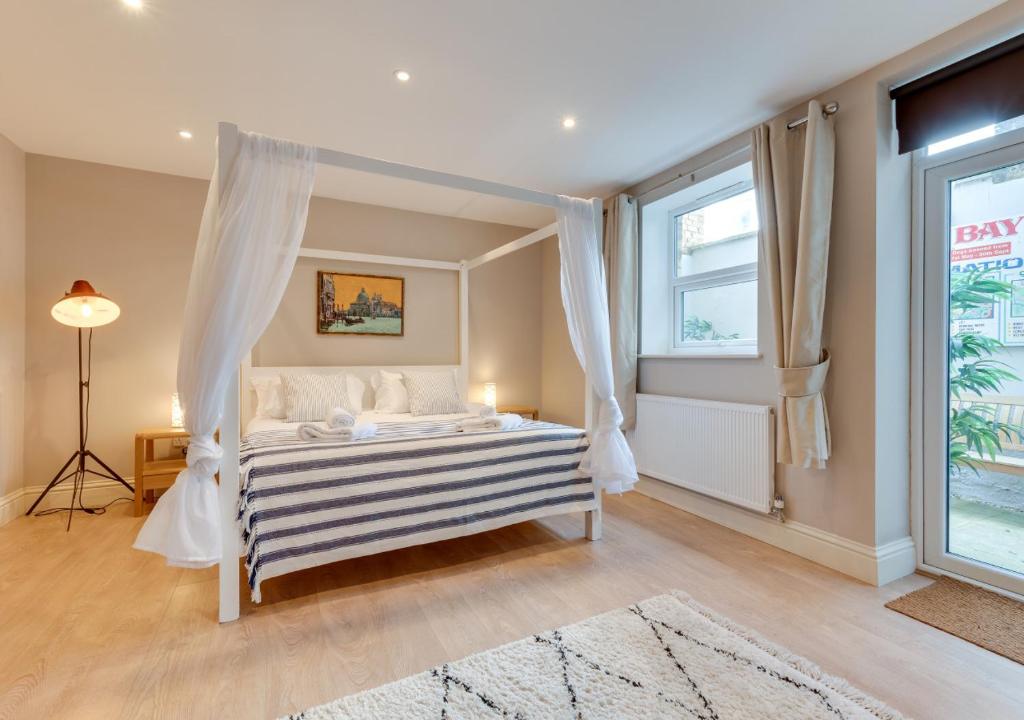 a bedroom with a bed with a canopy at Beachside Hideaway in Broadstairs
