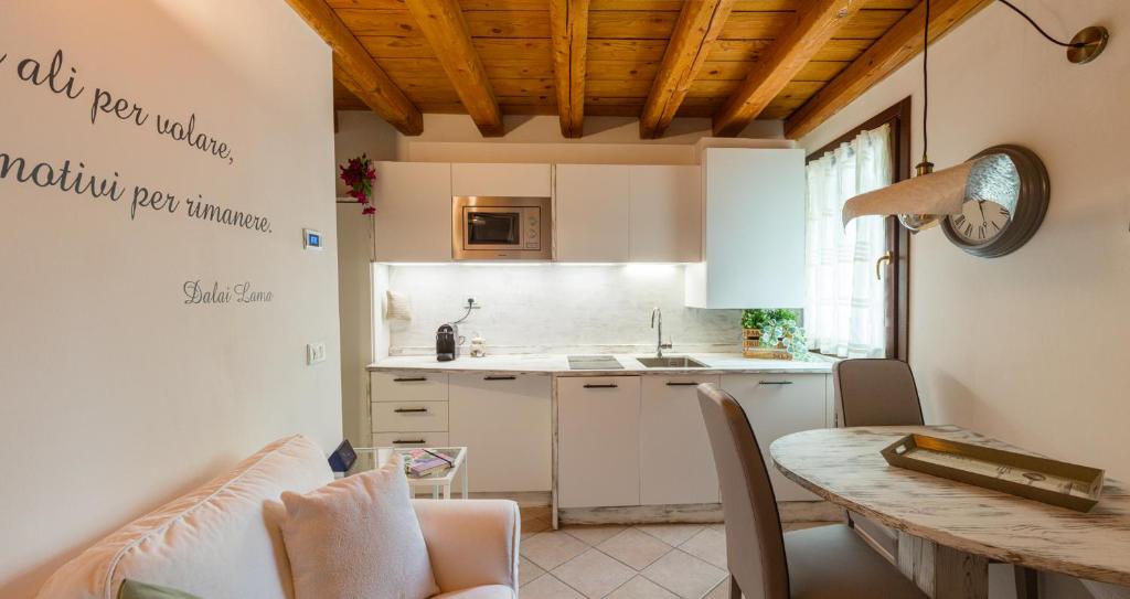 a kitchen with a table and a dining room at Kate's Home in Udine