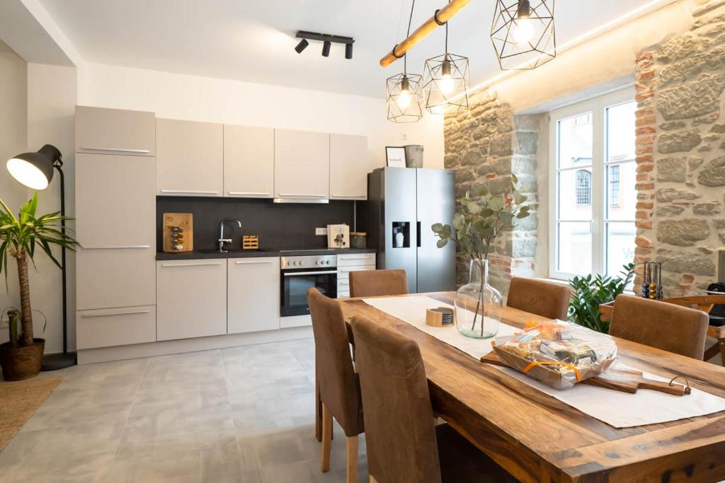 a kitchen and dining room with a wooden table at Luxury Apartment, in the Old Town on the Lake... in Überlingen