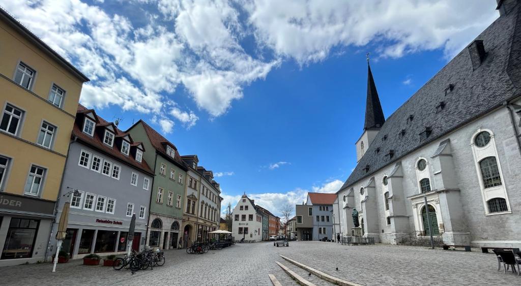 a city street with buildings and a church at Schlafen in Weimar in Weimar