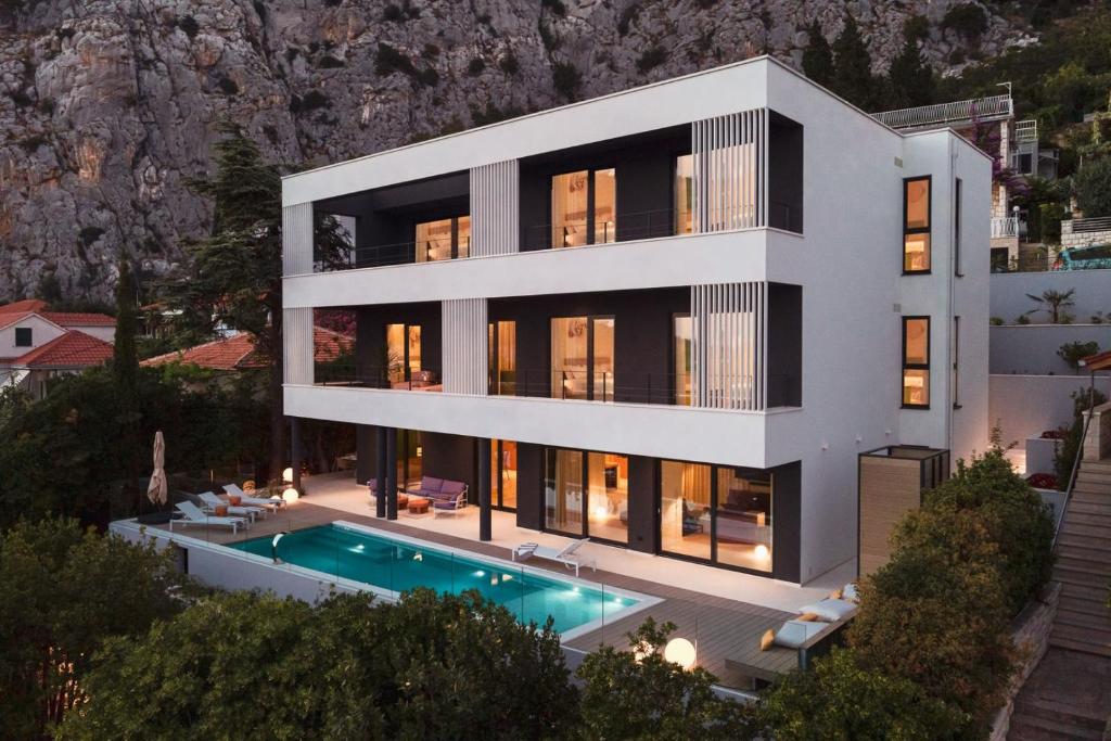 an aerial view of a house with a swimming pool at Seaview Villa Flora - Heated pool and Spa in Omiš
