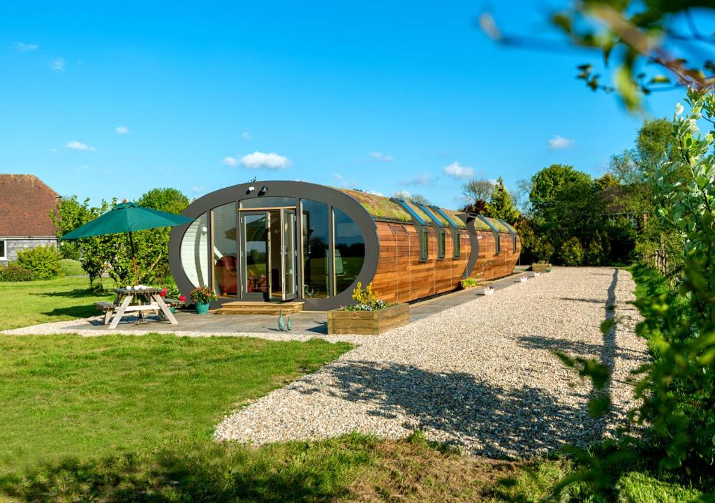 a tiny house with a circular roof on a yard at Bumble Barn in Lyminge