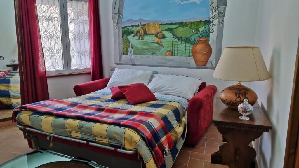 a bedroom with a bed and a lamp on a table at Casa Vacanze Nives in Tuscania