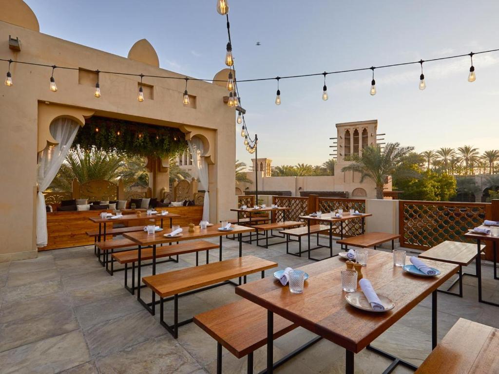 a restaurant with tables and chairs on a patio at amna in Fujairah