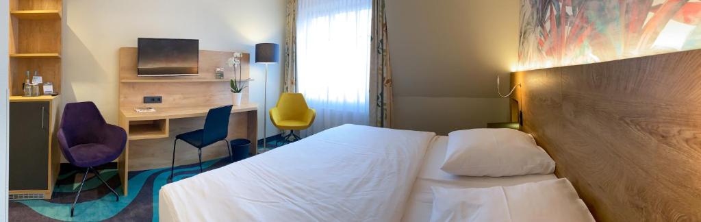 Postel nebo postele na pokoji v ubytování HKK Hotel Wernigerode