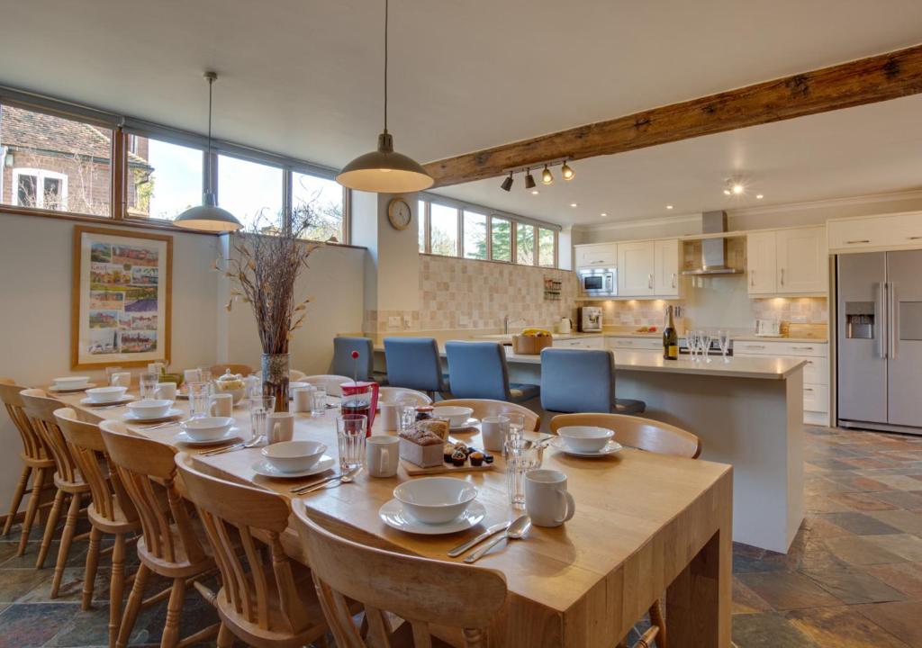 a large dining room with a long table and chairs at Hawkridge Oast in Sissinghurst