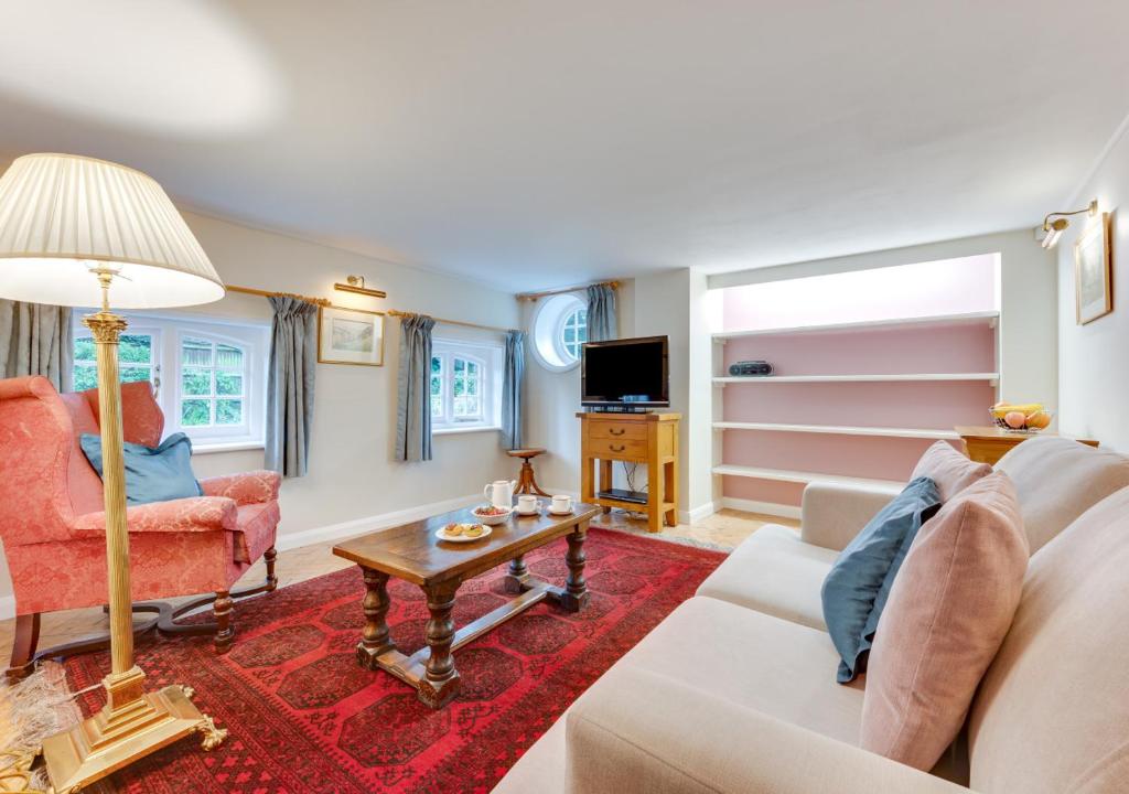 a living room with a couch and a table at Garden Flat in Sandwich