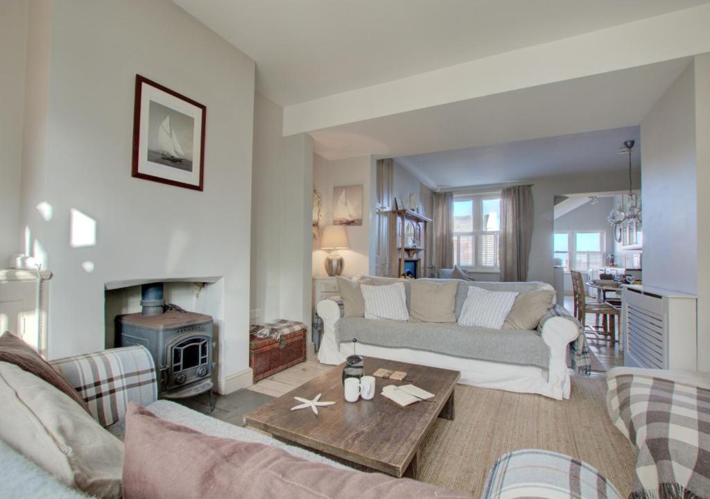 a living room with a couch and a table at Lower Coastguard Cottage in Hastings