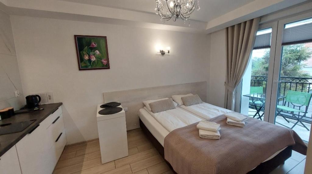 Posteľ alebo postele v izbe v ubytovaní Apartamenty Biała Perła