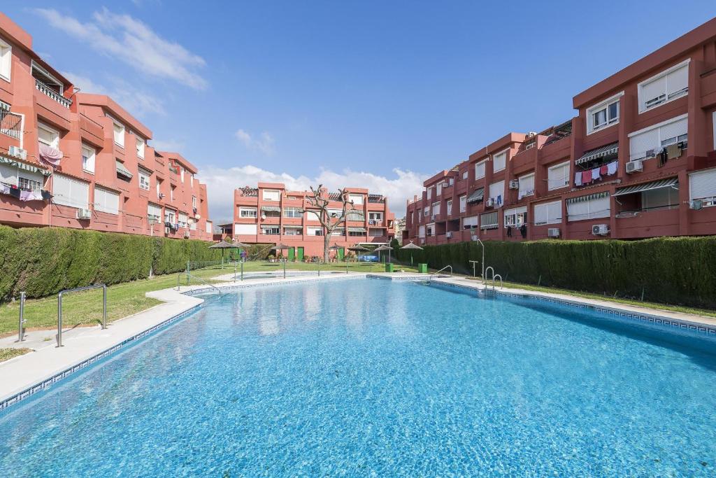 a large swimming pool in front of some apartment buildings at Camarote de Algetares in Algeciras