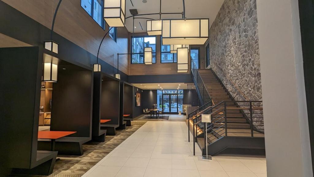 a lobby with a staircase and a stair case at Downtown One Loudoun in Ashburn