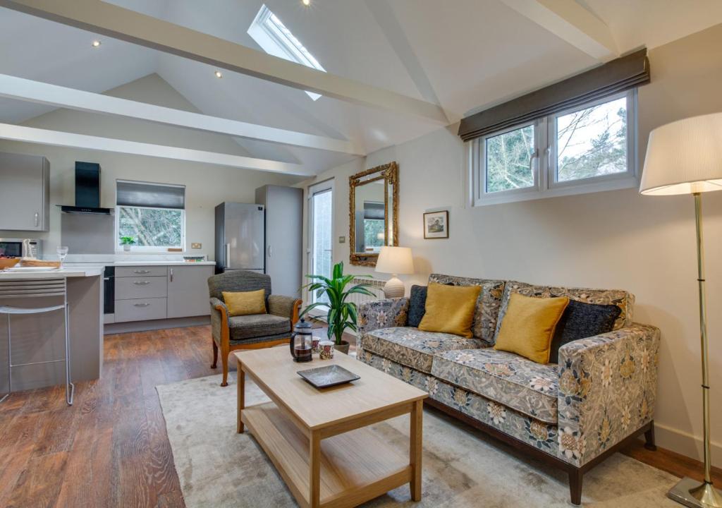 a living room with a couch and a table at The Garden Cottage in Nutley