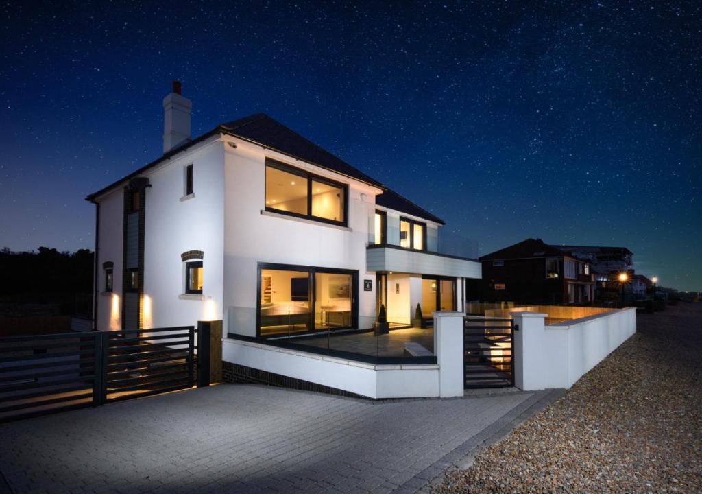 a large white house at night with the sky at Vause at Sea in Kingsdown