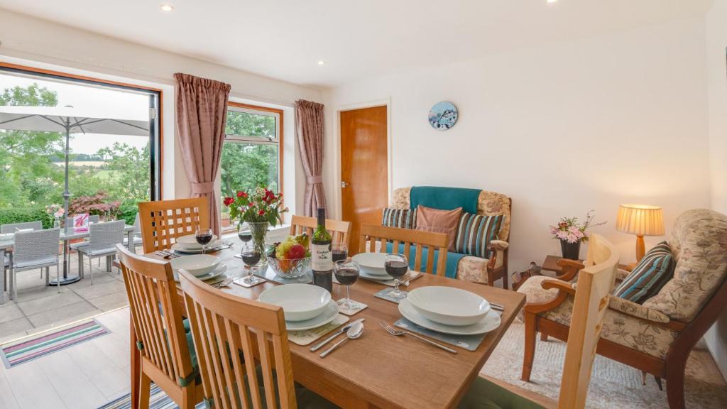 a dining room with a wooden table and chairs at Ellencroft in Unstone