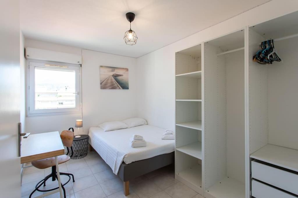 a bedroom with a bed and a desk and shelves at L41 Suite Paladium parking 8pax 4rooms balcony WIFI&#47;AC in Nice