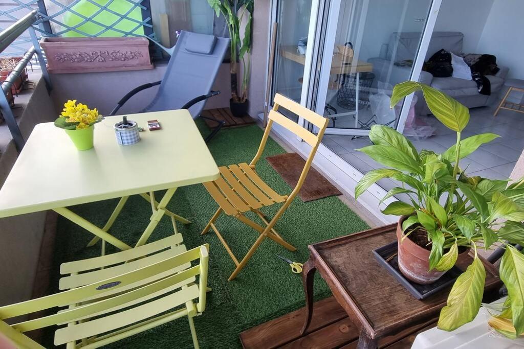 a balcony with a table and chairs and plants at L41 Suite Paladium parking 8pax 4rooms balcony WIFI&#47;AC in Nice