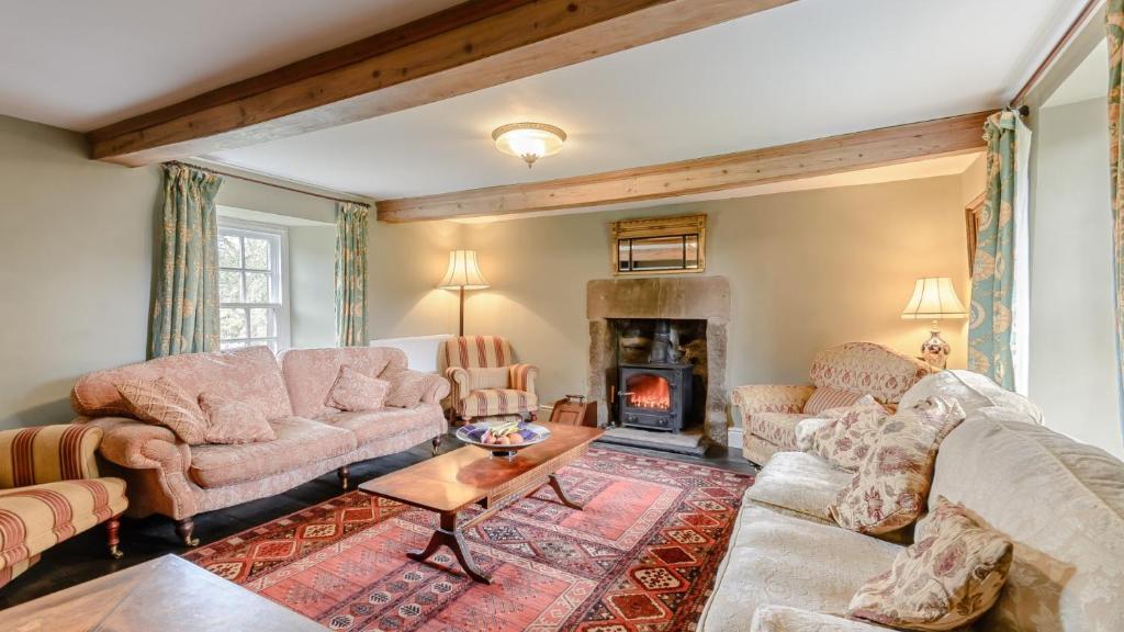 a living room with two couches and a fireplace at Elton House in Elton