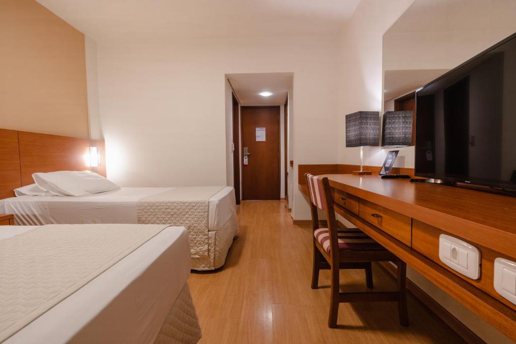 Postel nebo postele na pokoji v ubytování Hotel Caiuá