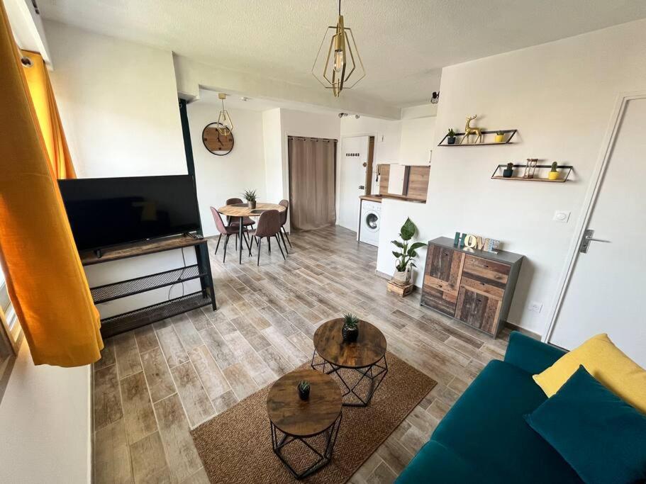 salon z kanapą i stołem w obiekcie grand studio proche plage w mieście Antibes
