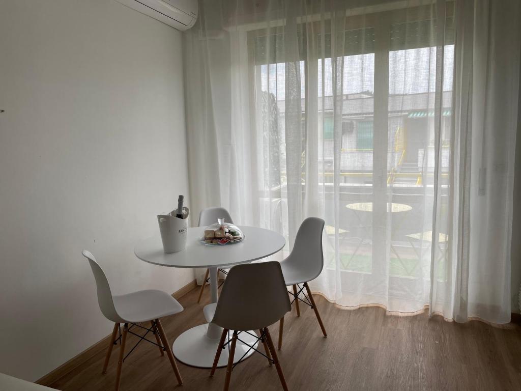 un tavolo bianco con sedie in una stanza con finestra di Dimora Dalmazia a Vasto