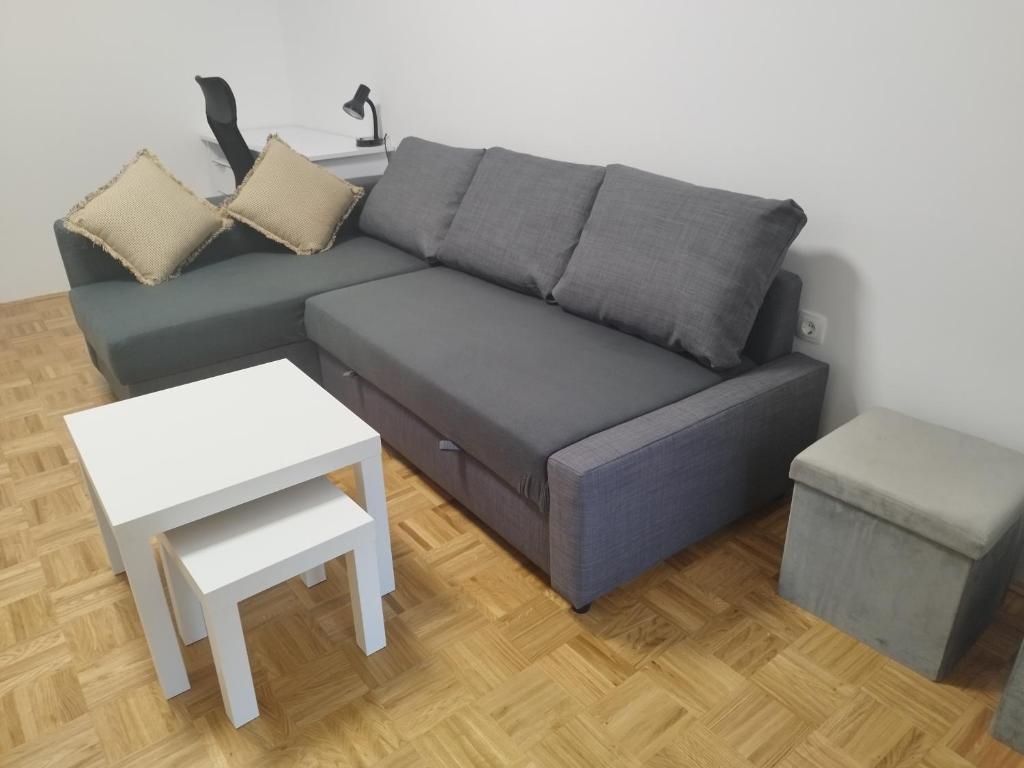 a living room with a couch and a table at Apartma MB center in Maribor
