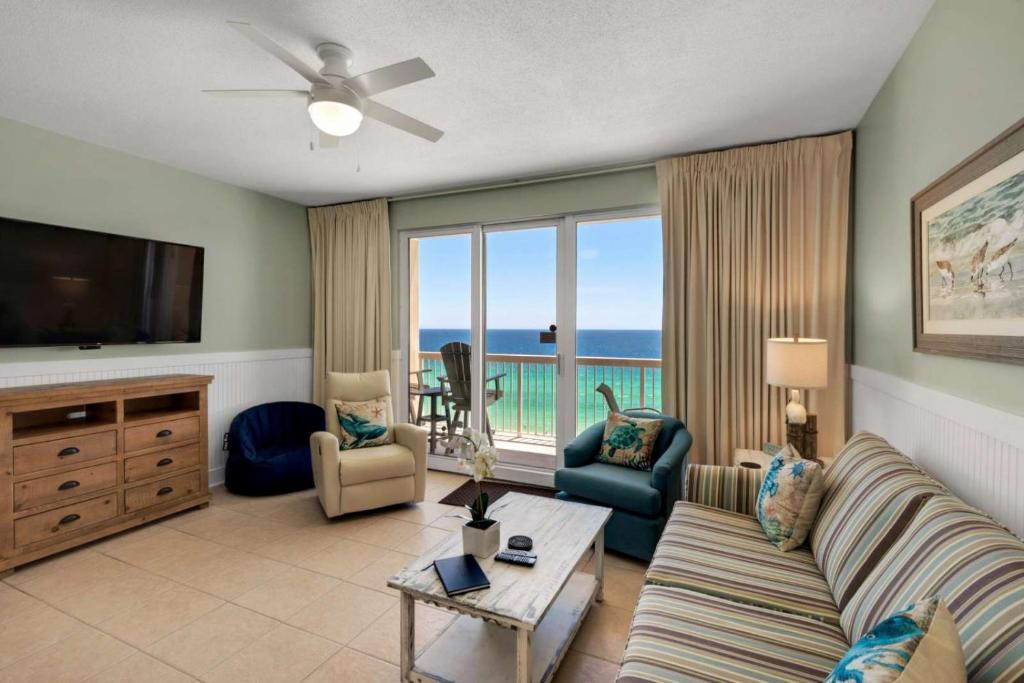 a living room with a couch and a flat screen tv at Seychelles 1007 in Panama City Beach