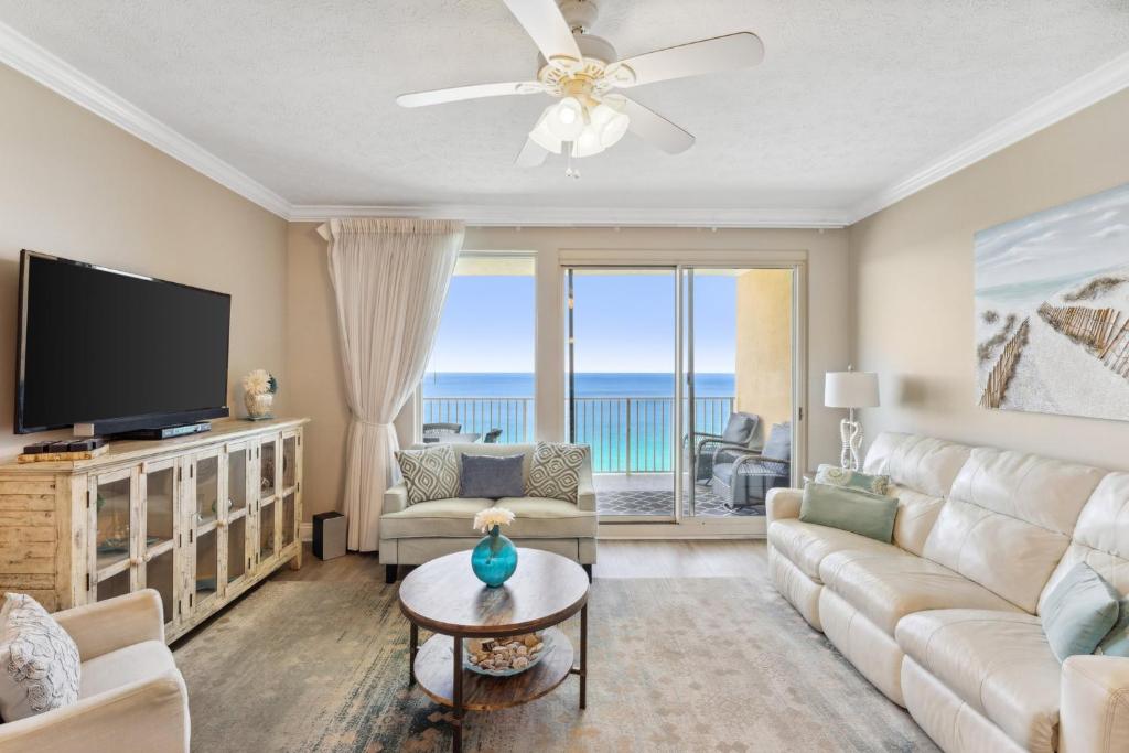 a living room with a flat screen tv and a couch at Treasure Island 1802 in Panama City Beach
