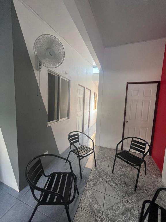 a group of chairs in a room with a staircase at Buganvilla No 3 in Quepos