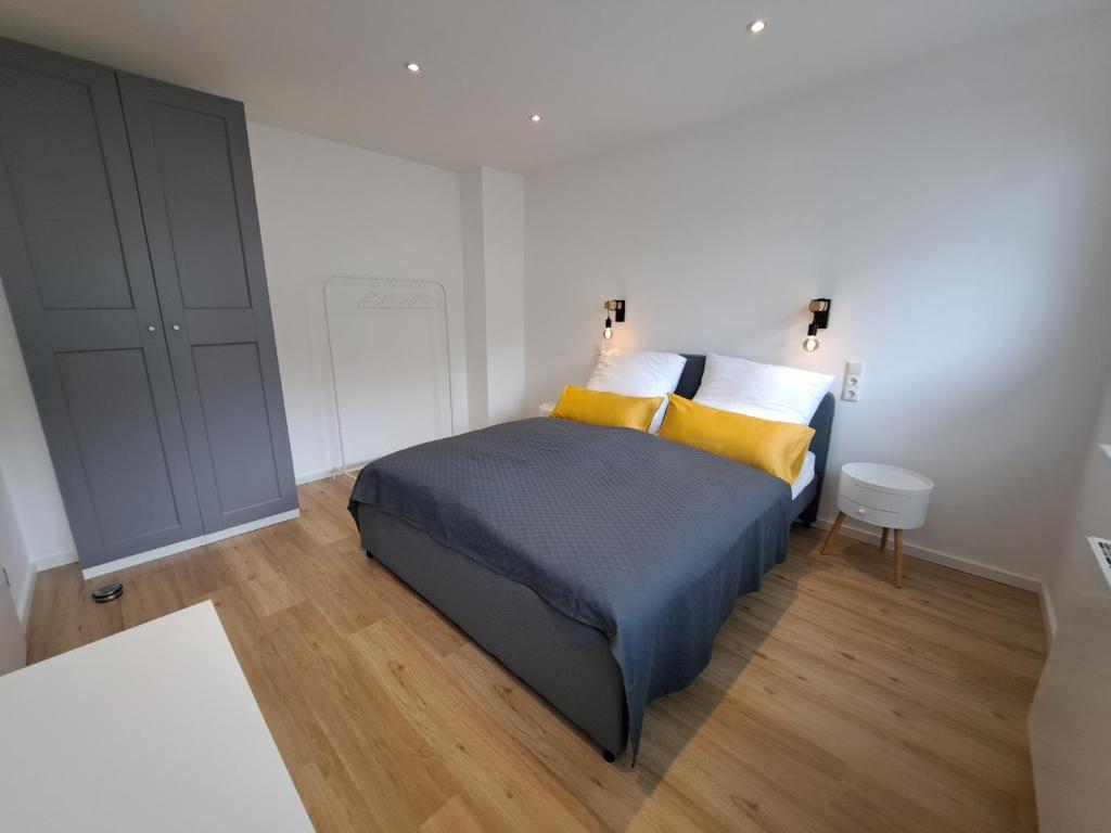 a bedroom with a bed with yellow pillows at Ferienwohnung Kreuztal in Kreuztal