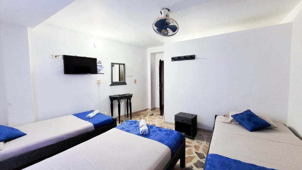 Postel nebo postele na pokoji v ubytování Hotel Acapulco Caucasia