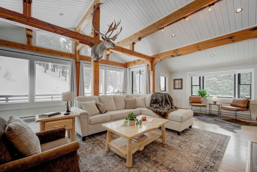 a living room with a couch and a table at Quinn Peaks Retreat House in Bozeman