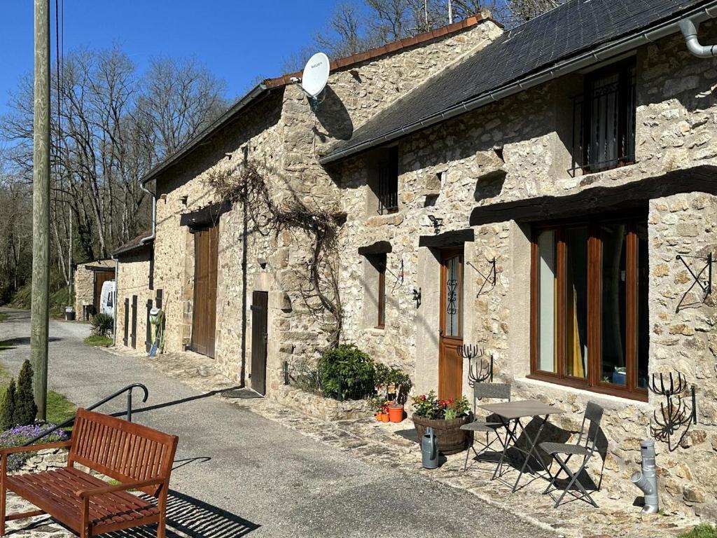 a stone building with a bench in front of it at Cottage - The Moulin Treillard - Sleeps3 - Parking in Saint-Hilaire-La-Treille