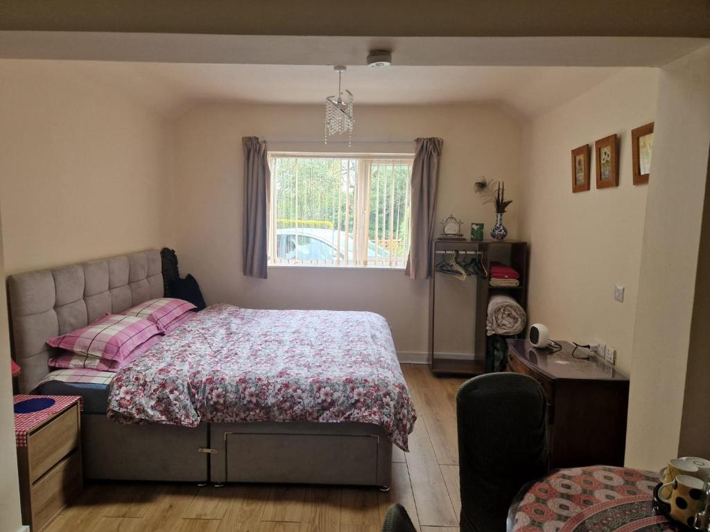 a bedroom with a bed and a window at Beautiful 1-Bed studio Lickey Hills Birmingham in Birmingham