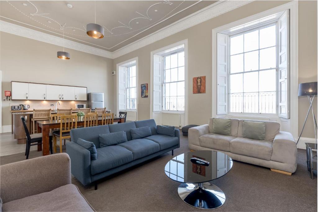 a living room with a couch and a dining room at York Place Apartments by Destination Edinburgh in Edinburgh
