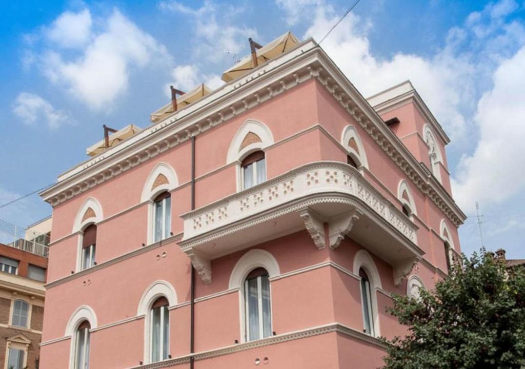 a pink building with a white trim at Relais Villa Coppedè in Rome