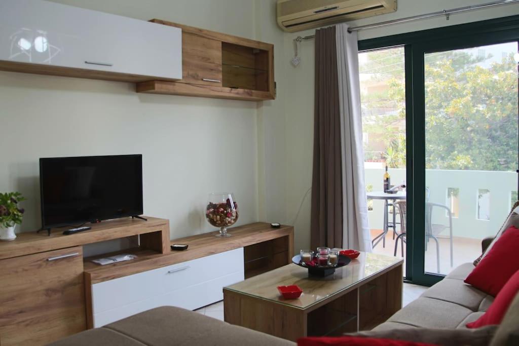 a living room with a couch and a tv at Anna Kavros appartment in Chania Town