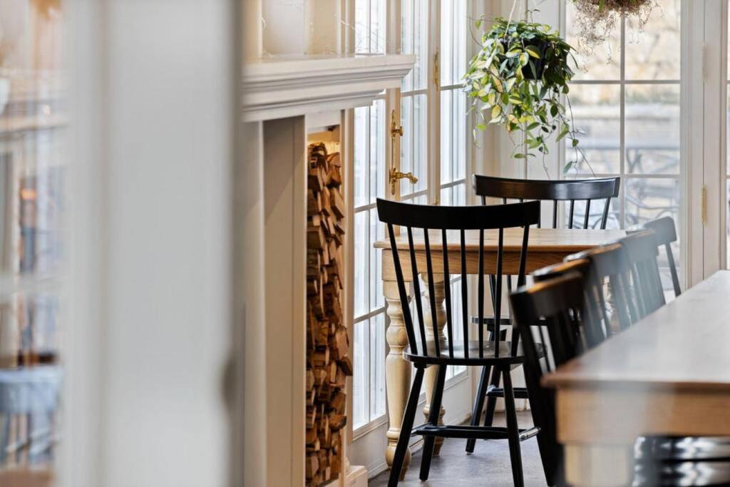 a room with a table and chairs and a fireplace at Mary Atkins at Southmoreland on the Plaza in Kansas City