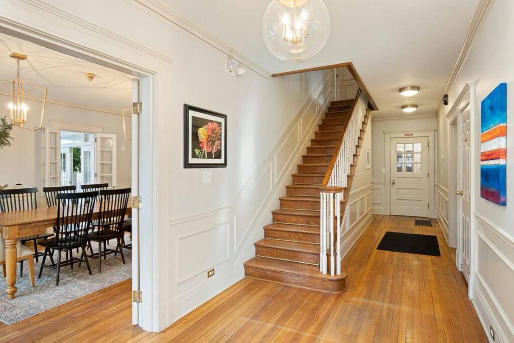 a staircase in a home with a dining room at George Caleb Bingham at Southmoreland on the Plaza in Kansas City