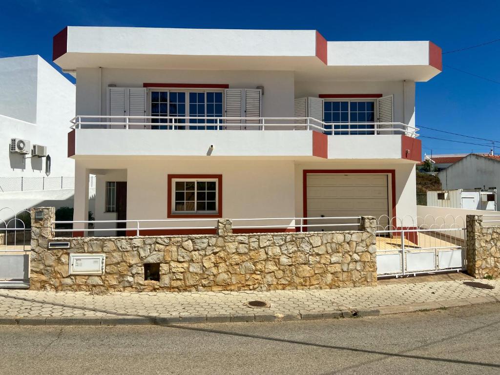 a white house with a stone wall at Spacious villa in Portimão ideal for families #1938 in Portimão