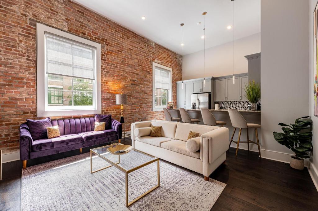a living room with a brick wall at The Endymion in New Orleans