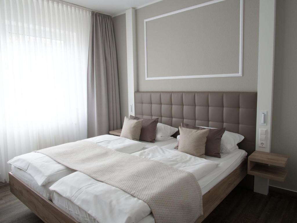 Postel nebo postele na pokoji v ubytování Hotel Greive