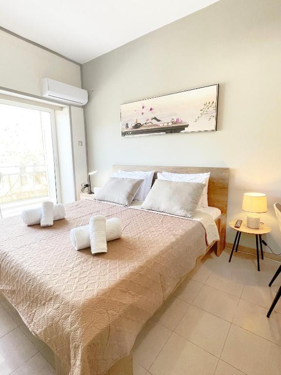 a bedroom with a large bed with towels on it at Rhodes Central: King Bed Studio in Rhodes Town