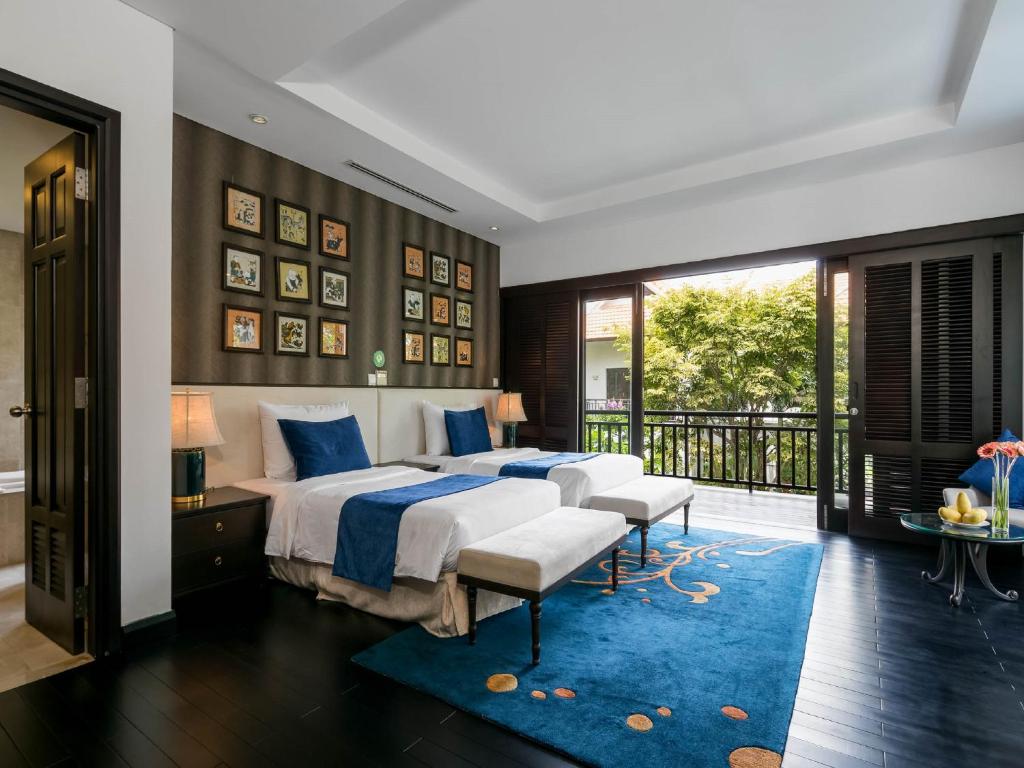 Postel nebo postele na pokoji v ubytování Danang Pool Villas Resort & Spa My Khe Beach