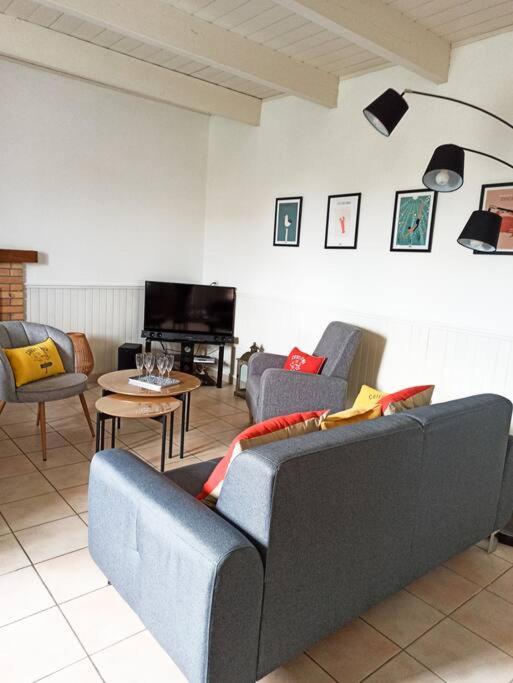 a living room with two couches and a television at Maison de pêcheur rénovée (new) in Ploubazlanec